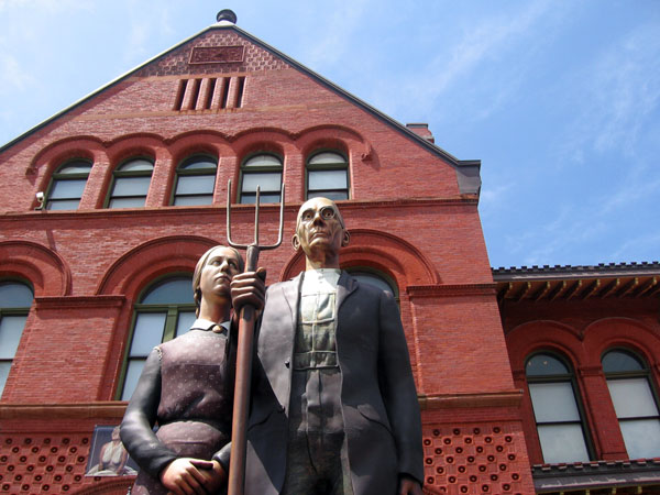A 25 foot tall lifesize replica of the American Gothic painting outside the Custom House Museum.